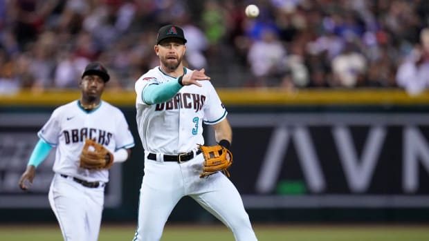 Diamondbacks third baseman Evan Longoria throws to first base for an out.
